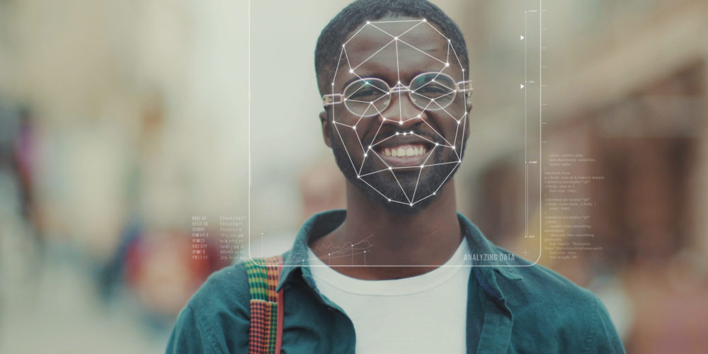 Male with face detection identity software Future. Face Detection. Face ID. 3D Identification of Handsome Smiling African American Man Student with Animated Dots and Grids. Biometrical Safe Human Face Scanning. Augmented Reality.